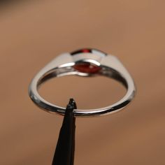 It is a natural garnet ring. The main stone is 5 mm* 10 mm marquise cut.weight about 1.35 carats. The basic metal is sterling silver and plated with rhodium. To change the metal to a solid gold (white/rose) or platinum is also available, please ask for a quotation if you want. You can also go to my shop Home for more elegant rings: https://www.etsy.com/shop/godjewelry?ref=hdr_shop_menu Garnet is January birthstone More garnet rings: https://www.etsy.com/shop/godjewelry?ref=seller-platform-mcnav& Jewelry Ad, January Birthstone Rings, Garnet Engagement Ring, Red Garnet Ring, Ring Marquise, Buying An Engagement Ring, Gifts Vintage, Vintage Style Rings, Natural Gemstone Jewelry