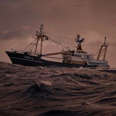 a large boat in the middle of the ocean with waves on it's side