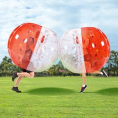 a man is running with two large balls in the shape of an american and north carolina flag