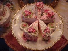 there are four pieces of cake on the plate with pink flowers in it and one slice is missing