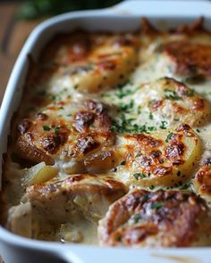 a casserole dish with meat and cheese in it on a wooden table top