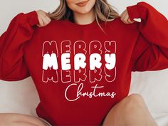 a woman wearing a red sweatshirt that says hot cocoa and christmas lights