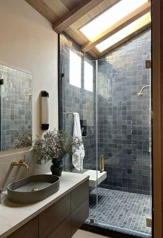 a bathroom with a sink, mirror and shower stall in the middle of it's walls