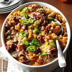 a white bowl filled with chili cheese and pasta