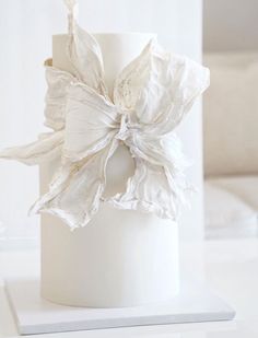 a close up of a white vase on a table