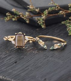 a close up of a ring on a wooden surface with flowers in the back ground