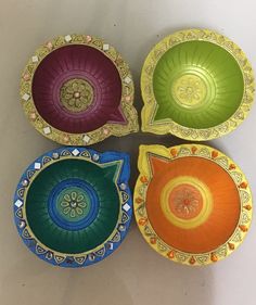 four colorful bowls with decorative designs on them