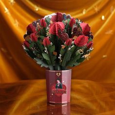 a vase filled with red roses on top of a table