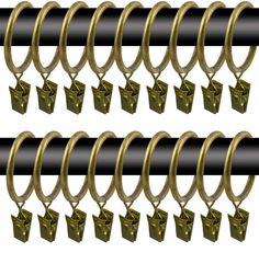 four pairs of brass - plated metal rings hang from black rods, each with an open end