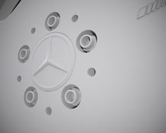 the mercedes logo is surrounded by smaller circles and holes in the wall that appear to have been cut out