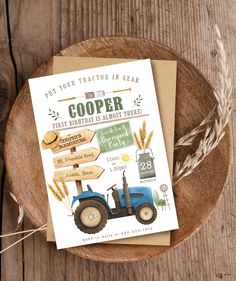 a farm tractor birthday card on top of a wooden plate