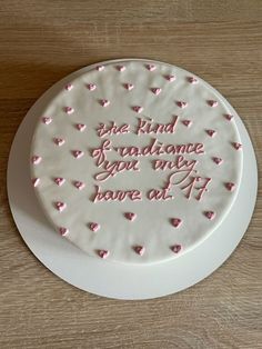 a white cake with pink hearts on it and the words be kind of guidance you only have at 11