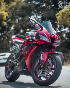 a red motorcycle is parked on the street