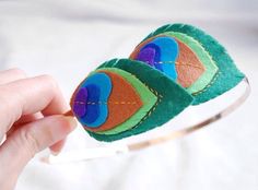 a hand holding a pair of eyeglasses made out of felt