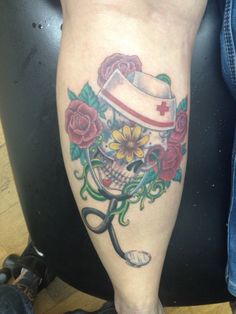 a tattoo on the leg of a person with scissors and a nurse's hat