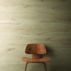 a wooden chair sitting in front of a wall with wood paneling on the walls