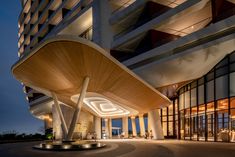 an outside view of a large building at night