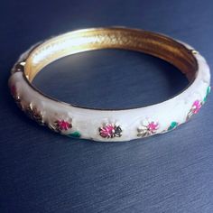 White enamel clasp bracelet bangle NEW. Pretty floral white enamel painted bangle with gold tone trim. Painted with pink and green flowers. Clasp closure. Diameter = 2.4 inches. Jewelry Bracelets White Bangle Bracelet For Spring, White Bangle Jewelry For Spring, Adjustable White Bangle, Adjustable White Vintage Bangle, Pink And Green Flowers, Clasp Bracelet, Floral White, Bracelet Clasps, Bracelet Bangle