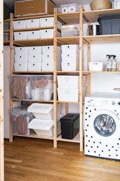 an organized laundry room with lots of boxes and bins on the shelves next to a washing machine