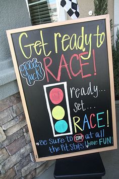 a sign that is posted on the side of a building saying get ready to race