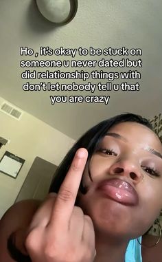 a woman is making a funny face with her finger to her ear and the caption reads, ho, it's okay to be stuck on someone i never dated but did not