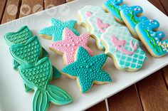 some decorated cookies on a white plate