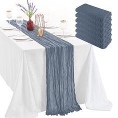 the table is set with place settings and napkins on it, along with wine glasses