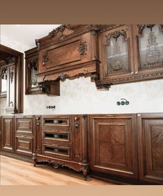 an ornate kitchen with wooden cabinets and wood flooring is pictured in this image from the front view