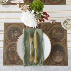 a place setting with silverware, flowers and napkins on a marble table top