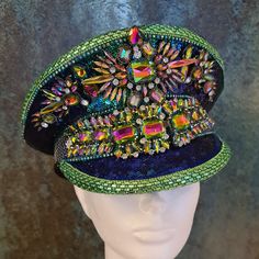 This embellished party hat features sequin fabric in chameleon blue-green . It is further covered with matching sequin and rhinestone trim and Dark Rainbow (green/purple AB) and Crystal jewellery findings. The overall hat colour very much depends on the light, it literally both green and blue, but with many shades. The base of the hat is made from quality wool mix fabric with a leather band inside the rim. The hat can be made in different sizes, but PLEASE SPECIFY YOURS BEFORE PURCHASE just in c Adjustable Multicolor Party Costume Hat, Adjustable Multicolor Costume Hats For Parties, Mardi Gras Party Costume Hat, Rhinestone Party Hat For Kentucky Derby, Carnival Party Costume Cap, Multicolor Costume Hats For Mardi Gras Party, Multicolor Mardi Gras Party Costume Hats And Headpieces, Multicolor Cap-shaped Party Costume Hat, Multicolor Cap Costume Hat For Party