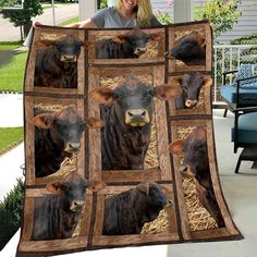 a woman holding up a blanket with cows on it