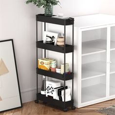 a shelf with various items on it next to a white wall and wooden flooring