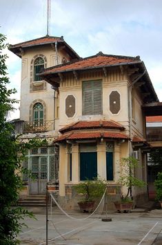 an old house with a hammock in front of it