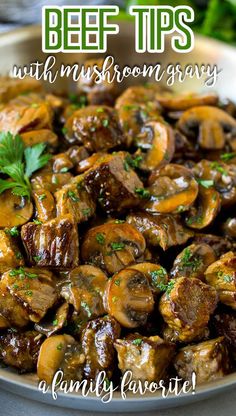 beef tips with mushroom gravy in a white bowl, garnished with parsley