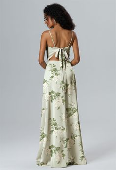 the back of a woman wearing a floral print dress with a halter top and high waist