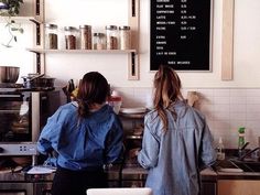 two women standing in front of a counter