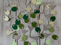 some green and white ornaments are on a wooden table