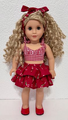 a doll with blonde hair wearing a red and white checkered top, skirt and red shoes