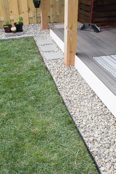 a dog is sitting on the grass in front of a house