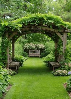 a wooden bench sitting in the middle of a lush green garden