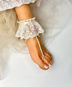 Ivory Lace  Barefoot Sandals, Bridal  Pearl Foot Jewelry, Wedding Footless Sandal, Beach sandals,Customizable Handmade-SD073   These Ivory lace footless sandals are the perfect accessory for a beach or garden wedding. They are handmade with a French lace applique highlighted with touches of  pearl. The sandals are incredibly comfortable and adjustable to fit every foot.  Model Size is US 7.5 . Summer Beach Lace-up Sandals With Cushioned Footbed, Beach Lace-up Sandals With Removable Insole, Beach Lace-up Sandals With Removable Insole And Open Toe, Lace-up Beach Sandals With Cushioned Footbed, Cream Open Toe Lace-up Sandals For Beach, Foot Jewelry Wedding, Sandals Bridal, Lace Barefoot Sandals, Womens Wedding Shoes