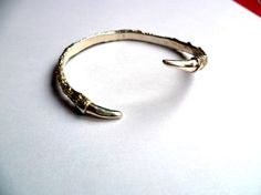 Bird talon claw cuff silver bracelet Gold Bracelet With Oxidized Finish As A Gift, Elegant Claw-shaped Metal Jewelry, Silver Hand Cast Brass Cuff Bracelet, Unique Sterling Silver Gold Bangle, Gold Cuff Bracelet With Oxidized Finish Gift, Gold Oxidized Finish Cuff Bracelet Gift, Silver Brass Bracelets Hand Cast, Formal Hand-cast Metal Bracelets, Gold Bangle With Oxidized Finish For Gift