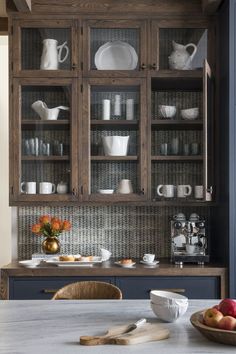 a kitchen with blue cabinets and white dishes