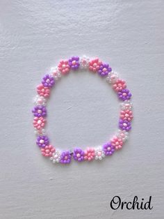 🌼 This orchid bracelet is perfect to wear with everything and makes a great gift. 🌸 The colors that this bracelet comes in are pink, orange, yellow, green, blue, purple, champagne, orchid, and lemonade. 🌼 Cute, dainty, and colorful beaded flower bracelets. 🌸 Using the sizing guide, select the appropriate size for your wrist measurement. Purple Flower Shaped Beaded Bracelets, Pink Flower Beaded Bracelets For Summer, Purple Flower-shaped Beaded Bracelets, Pink Flower-shaped Jewelry With Colorful Beads, Handmade Purple Flower Beaded Bracelets, Purple Beaded Flower Bracelets, Pink Tiny Beads Jewelry For Spring, Purple Flower Bracelets For Friendship, Pink Bracelets With Flower Decoration As Gift