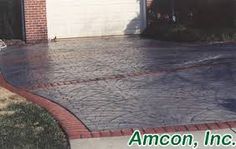 a brick driveway with an attached garage door