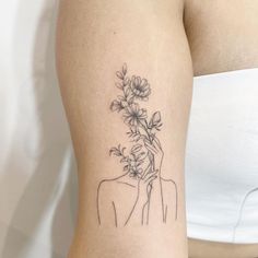 a woman with a flower tattoo on her arm