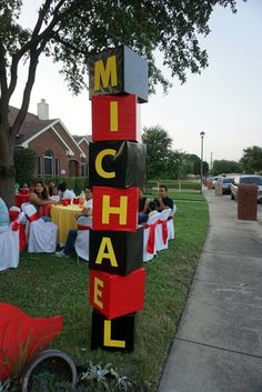 a sign that says michael on it in front of some people sitting at a table