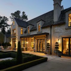 a large house with many windows lit up at night