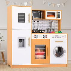 a play kitchen with an oven, microwave and washing machine