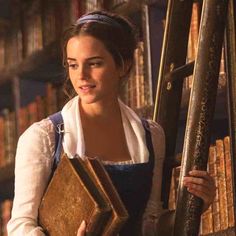 an image of a woman holding books in the library